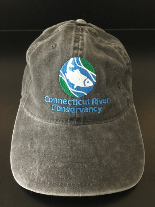 Dark grey cap with the CRC's fish logo in the center of the camp. Below the logo the text reads "Connecticut River Conservancy" in light blue.